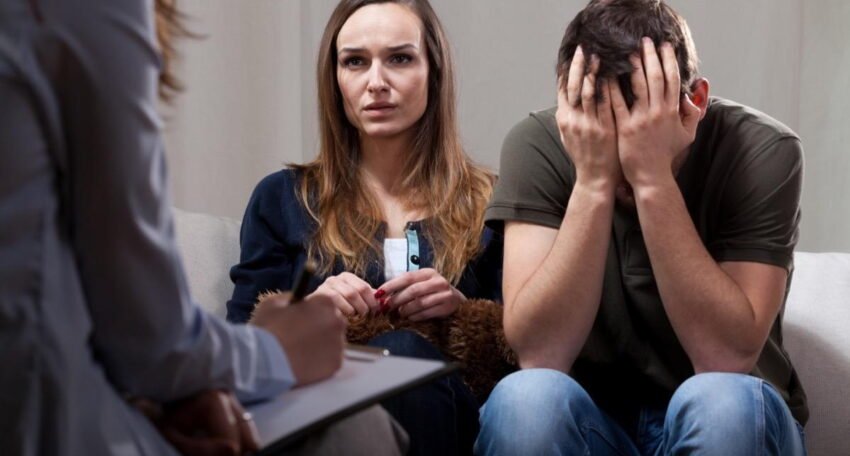 Couple attending a counselling session with a therapist.